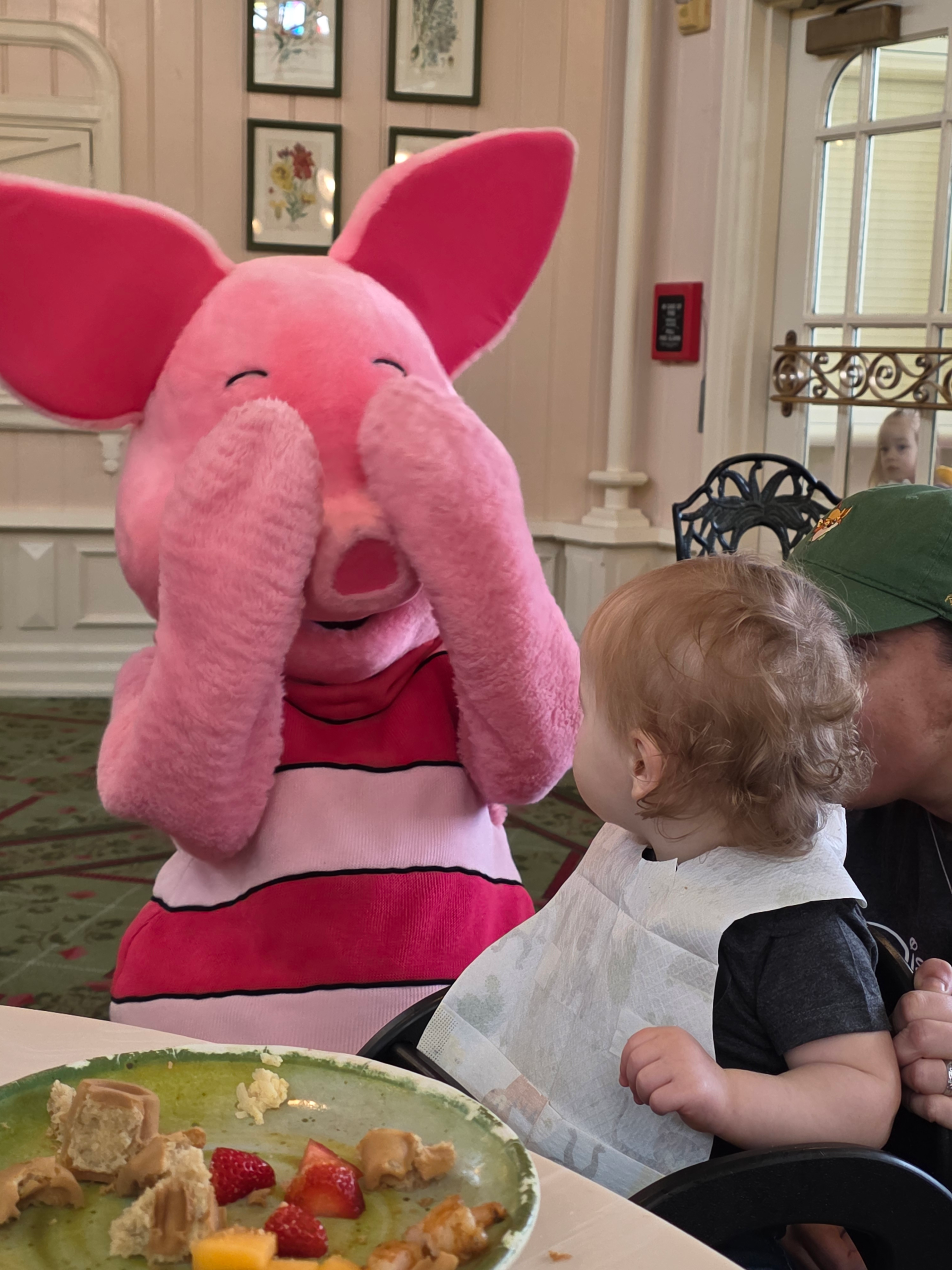 Skippy playing peek-a-boo with Piglet at the Crystal Palace in Magic Kingdom